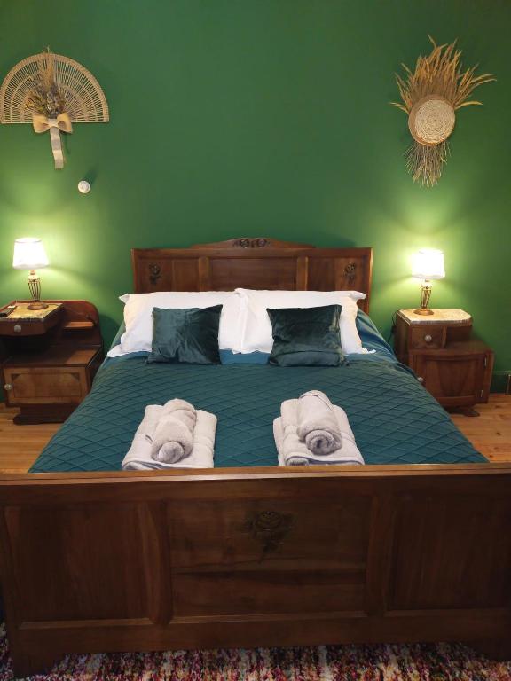 a bedroom with a large bed with towels on it at Chez jacky in Serres