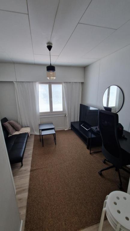 a living room with a couch and a table at Economy stay - Self Check-in in Vaasa