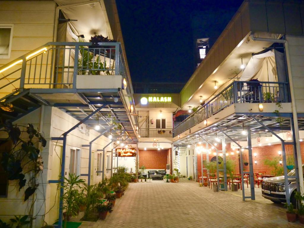 a building with a courtyard with plants and lights at Kalash Parkaze Glamping Hostel in Pokhara