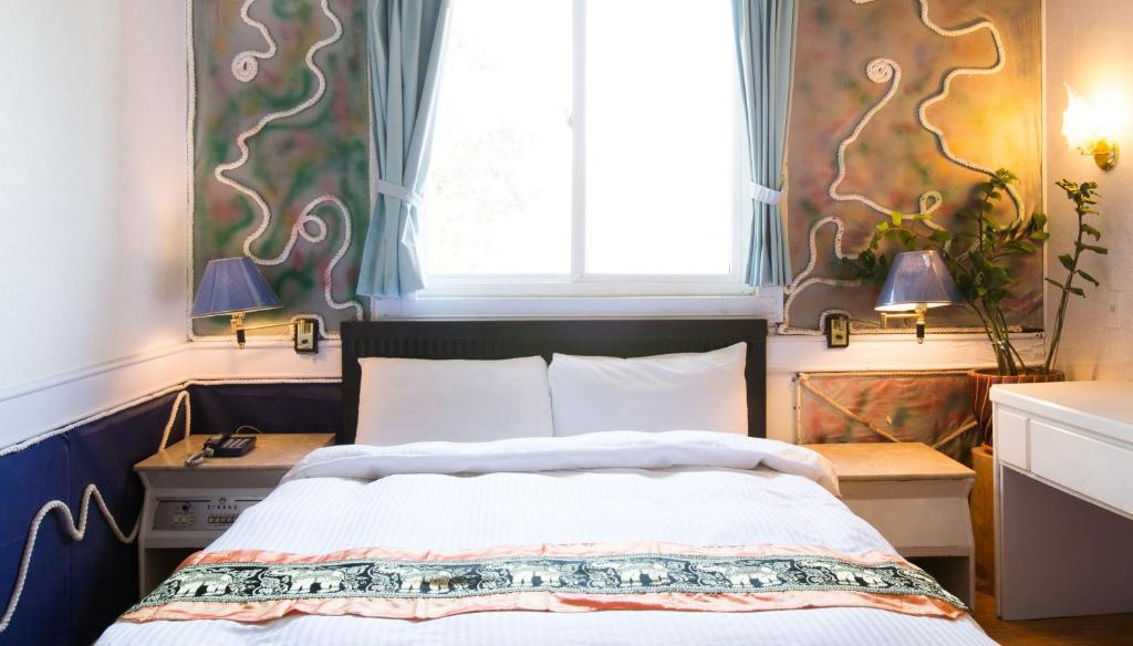 Postel nebo postele na pokoji v ubytování Dajenshan Hotel