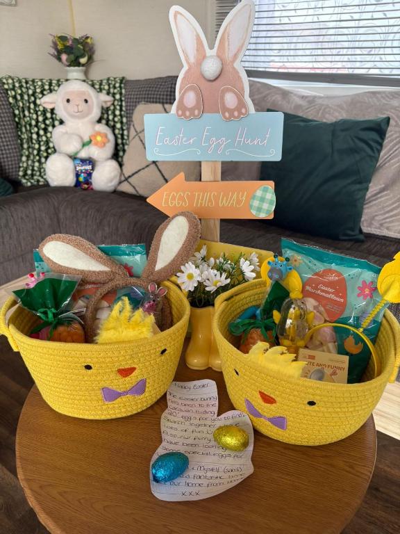 two baskets filled with easter eggs on a table at Centrix at Seawick Holiday Park in Saint Osyth