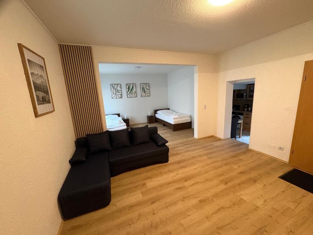 a living room with a black couch in a room at Ferienwohnung Sofia in Marl