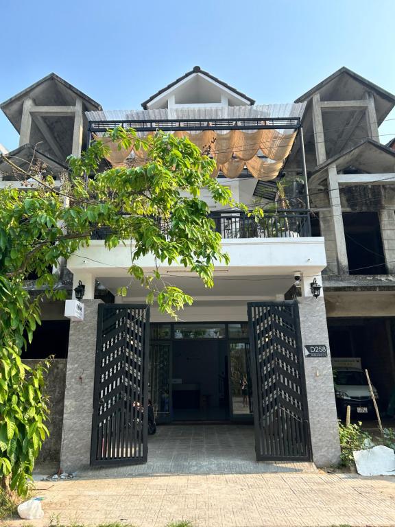 an entrance to a house with a black gate at Cốm Homestay in Hue