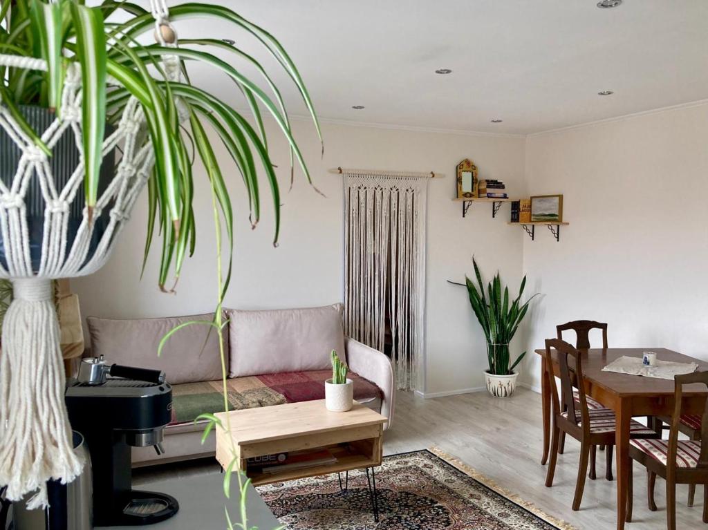 a living room with a couch and a table at OM East in Aizpute