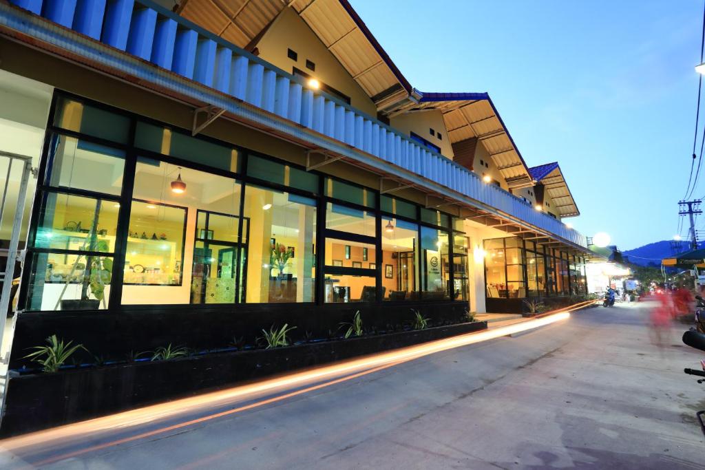 a building with large windows on a city street at Harmony Bed & Bakery in Ko Lipe