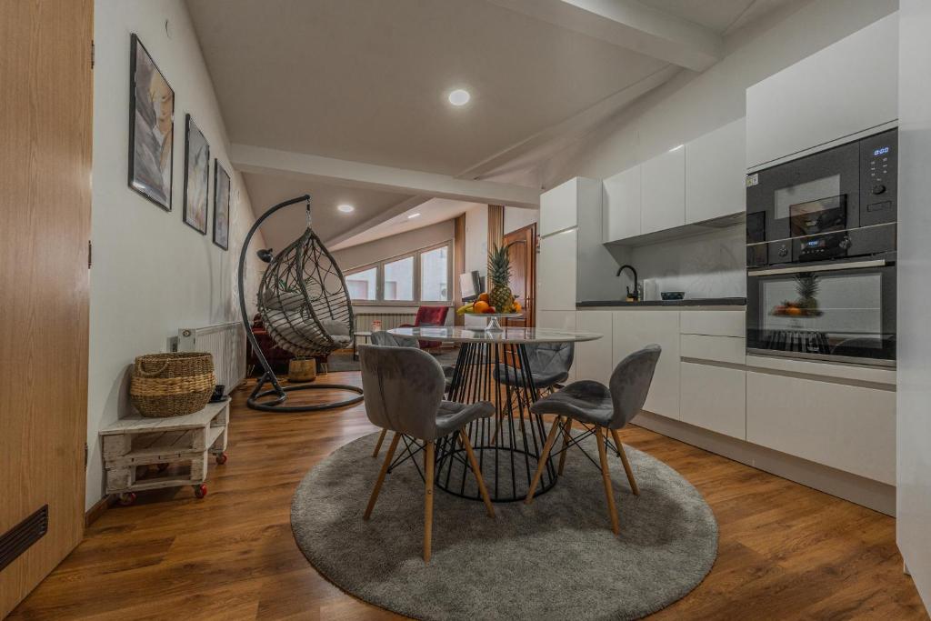 a kitchen with a table and chairs in a room at Apartman Draga in Varaždin