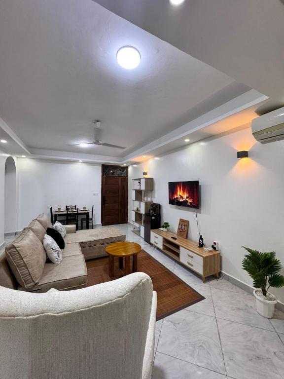 a living room with a couch and a fireplace at Two bedroom, Nyali rd in Mombasa