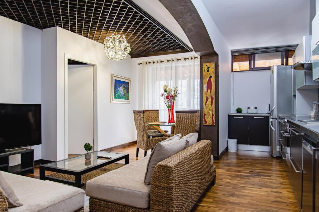 a living room with a couch and a table at Central Blloku 2 bedroom Apartment in Tirana