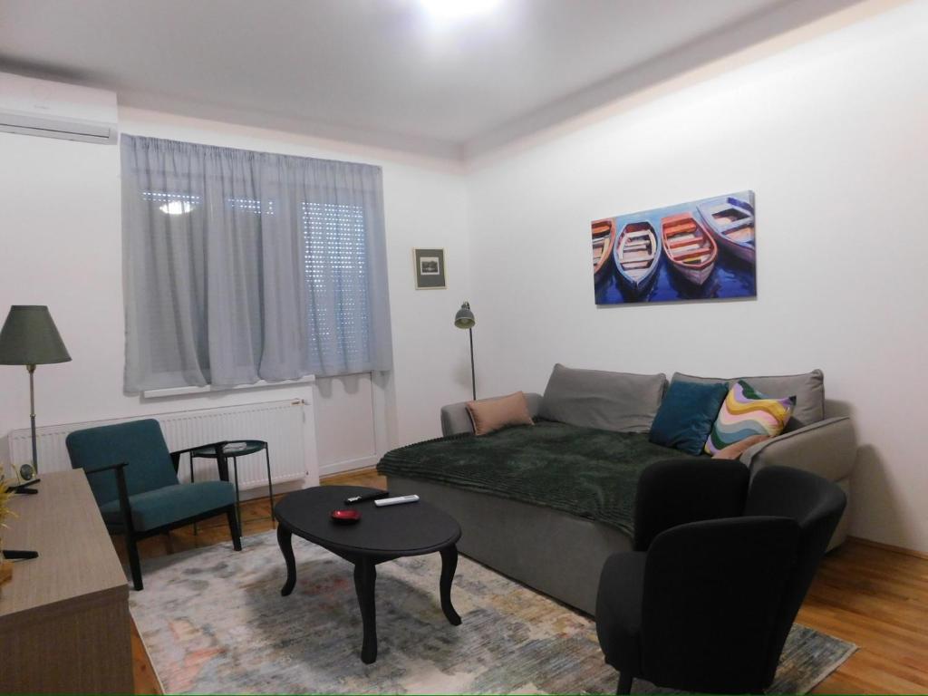 a living room with a couch and a table at Cetinjska apartment in Belgrade