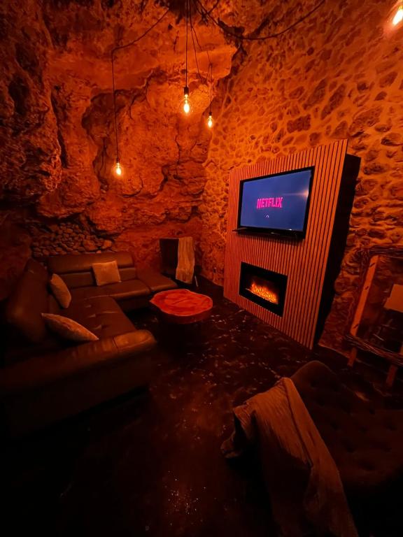 a living room with a fireplace and a tv at Villa Gloria in Tourtour
