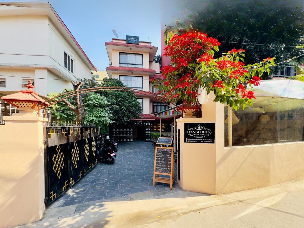 a building with a restaurant with flowers on the wall at Yangchen Home Hotel in Kathmandu