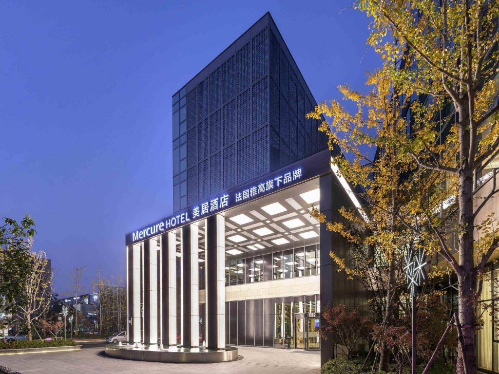a building with a sign on the front of it at Mercure Kunshan Hi Tech Zone in Kunshan