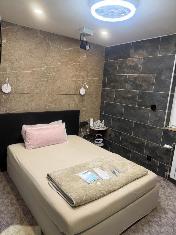a bedroom with a bed in a room with tiles at WKI Company in Mannheim