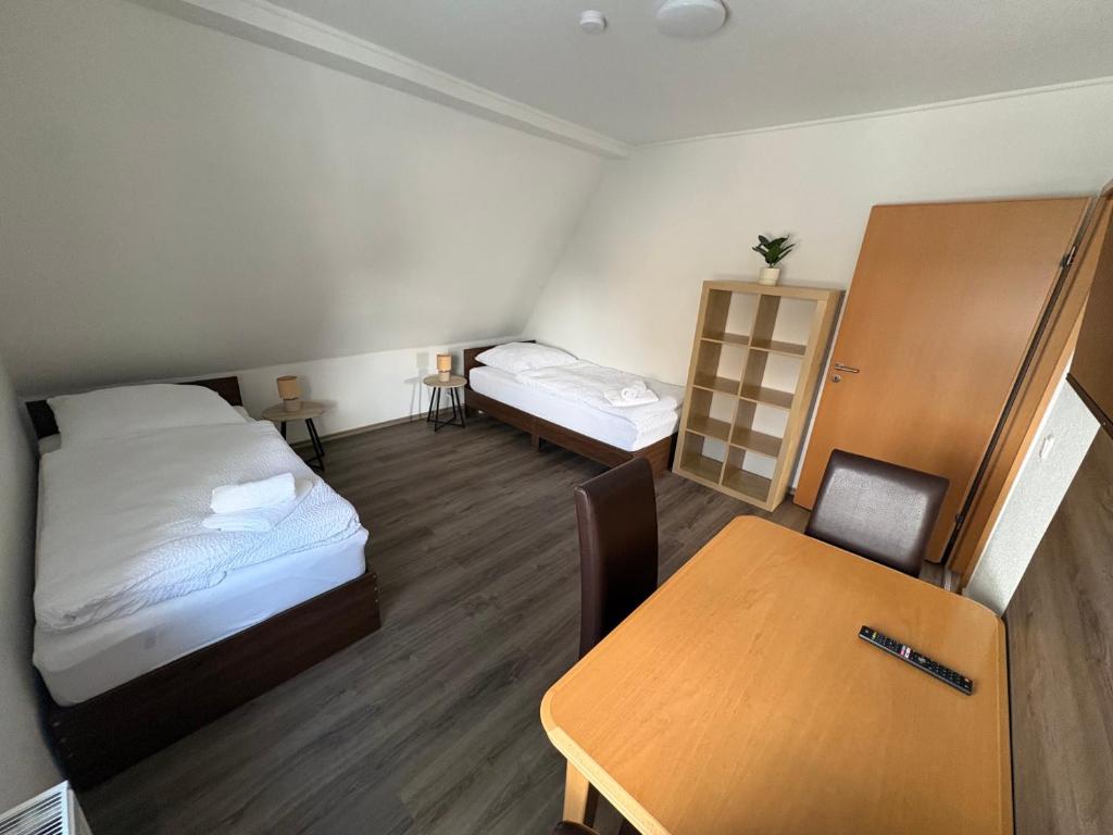 a small room with a bed and a table at Ferienwohnung Emma in Marl