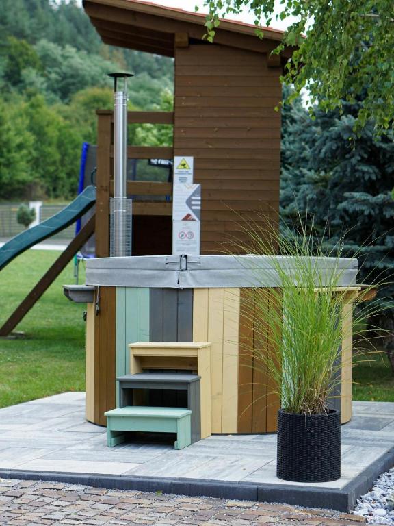 a play structure with a playground in a park at Relax House in Praid