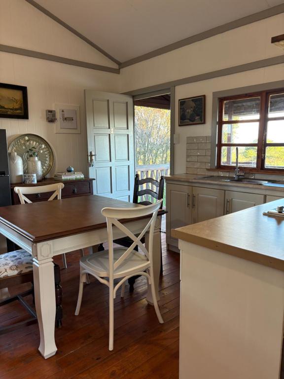 a kitchen with a table and chairs in a room at The Cabin at Skyfall Country Estate in Polokwane