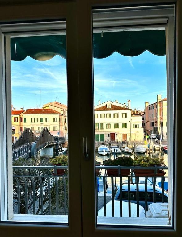 a view of a harbor from a window at el Capitan de Mar in Chioggia