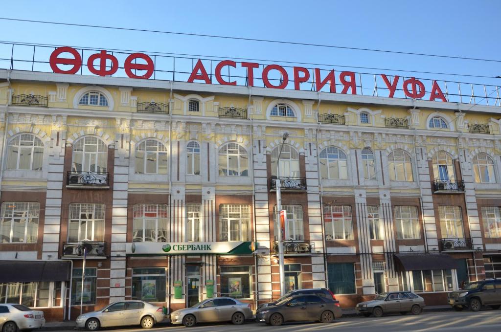 a large building with cars parked in front of it at Гостиница Уфа-Астория in Ufa