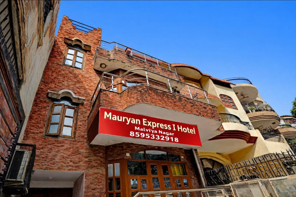 a building with a sign on the side of it at Mauryan Express I Hotel Malviya Nagar in New Delhi