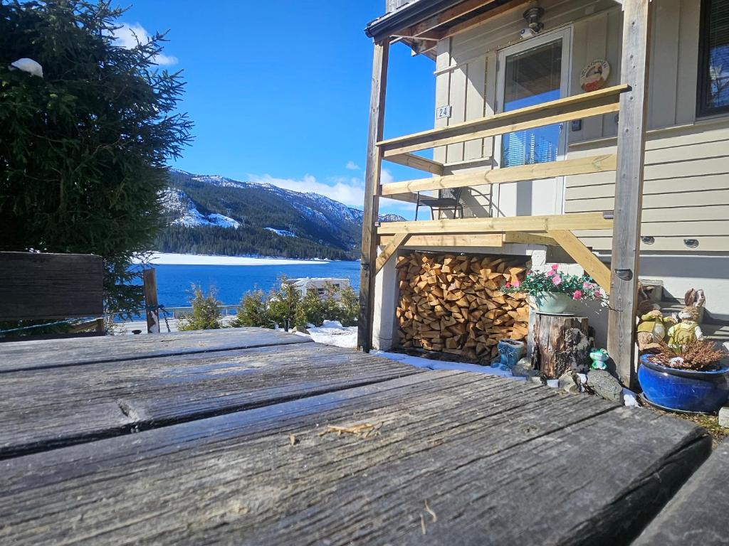 a house with a wooden deck with a fire place at HOL Familie Hous in Hol