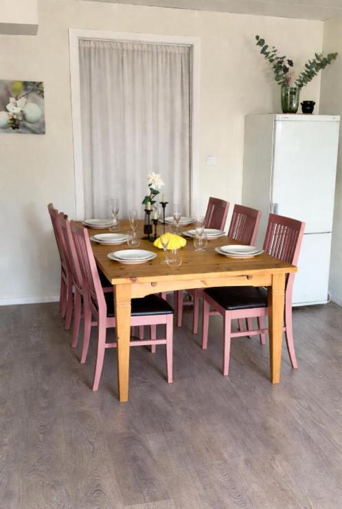 a dining room table with chairs and a wooden table at Bryggans Vandrarhem in Västervik