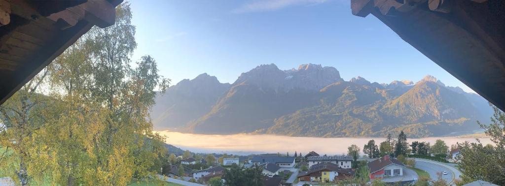 a view of a mountain range with a town and houses at s`gmiatli in Iselsberg