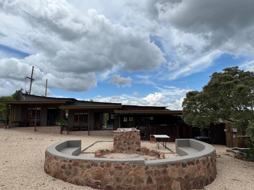 a building with a fire pit in front of it at Boskoors in Hammanskraal