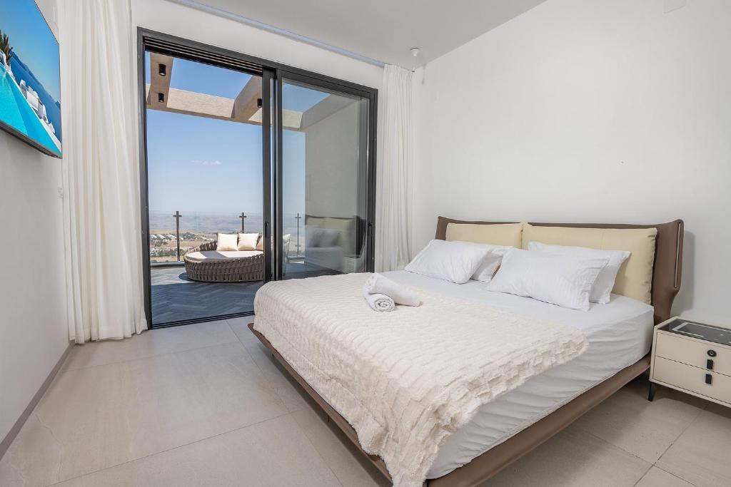 a bedroom with a bed with a view of the ocean at רויאל טווינס בוטיק in Safed