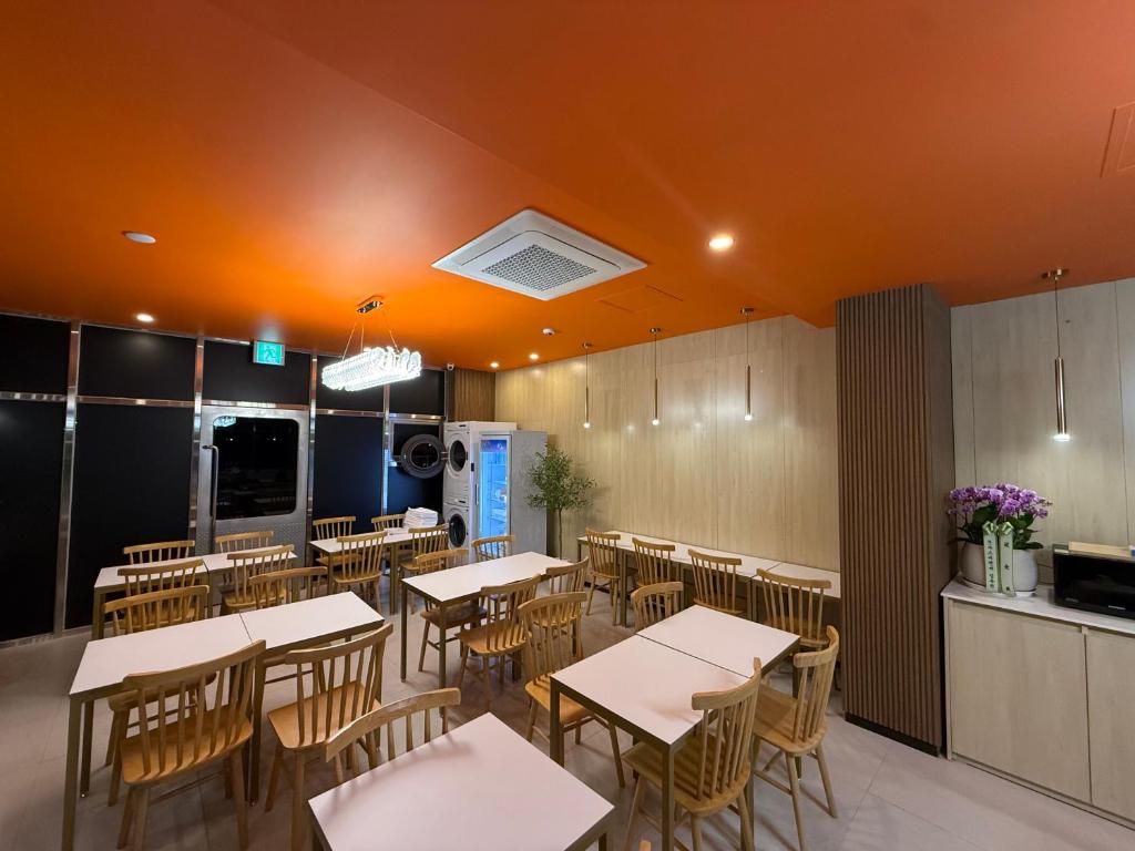 an empty dining room with tables and chairs at Latree Hotel in Seoul