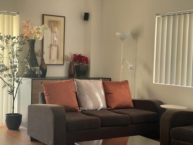 a living room with a couch and a table at Lidcombe Olympic Park Dudley in Auburn