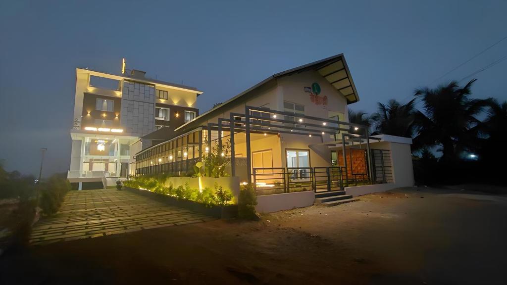 a house with lights on in front of a building at O'Nest Select in Peth