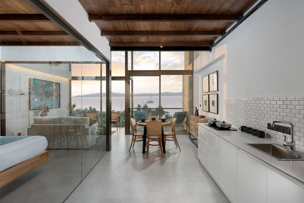 a kitchen and living room with a table and chairs at The Loft Mirissa in Mirissa