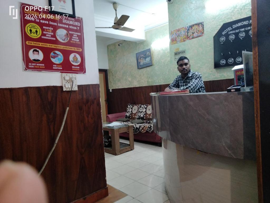 a man standing at a counter in a fast food restaurant at Hotel Diamond palace 45C in Chandīgarh