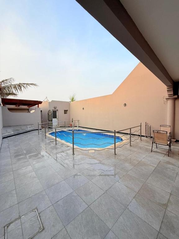 a large swimming pool in a building with a tile floor at فلة درة العروس in Jeddah