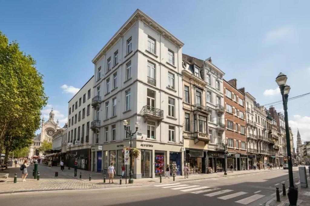a large white building on a street in a city at Le Catherine by Sweett in Brussels