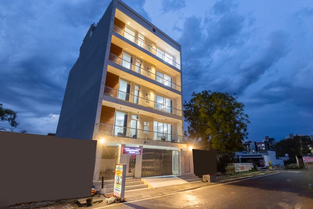 a tall building with lights on in a street at Yashobhoomi Suites near Yashobhoomi Convention Centre in New Delhi