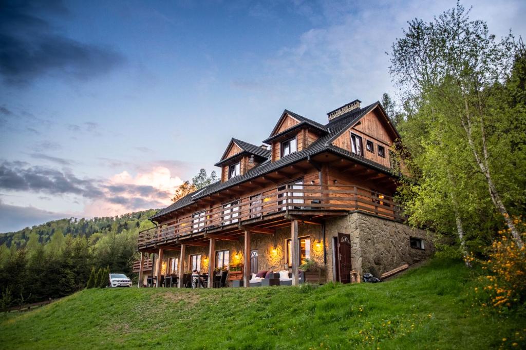 a large wooden house on top of a hill at Barnilka House Klimkówka in Klimkówka