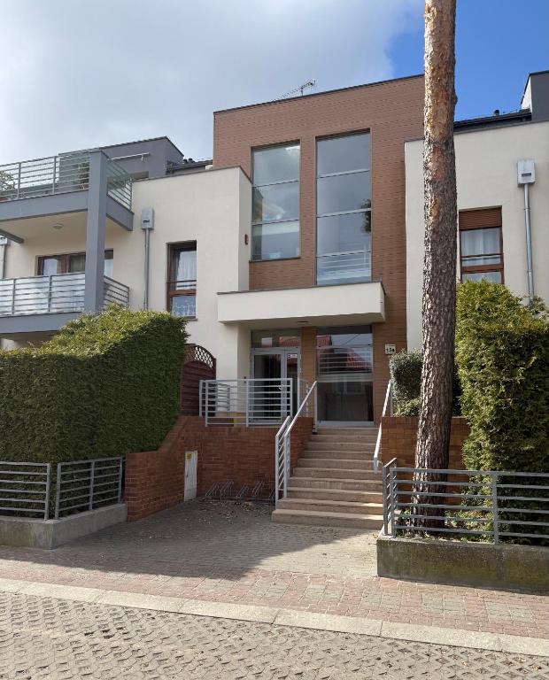 a building with a staircase in front of it at Apartament Gardenia Sun in Międzywodzie