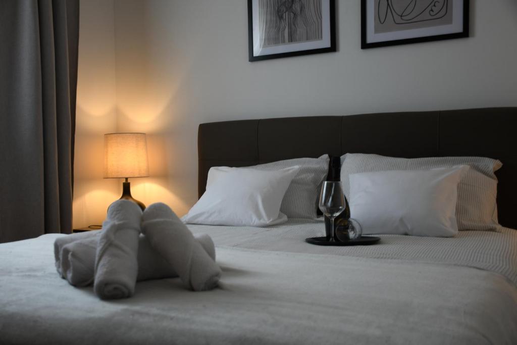 a stuffed animal laying on a bed next to a lamp at Valuna - Modern Sea View Apartment -Terrace - 4 Min to Beach - Free Parking in Jadranovo
