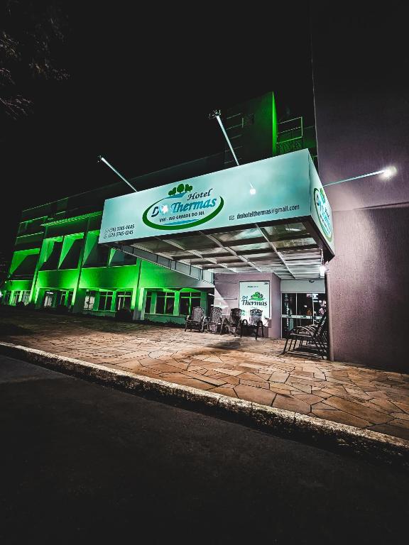a gas station at night with green lights at DM Thermas Hotel Iraí in Iraí
