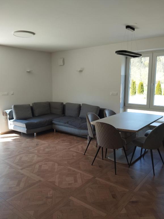 a living room with a couch and a table at POČITNIŠKA HIŠA Jan in Mišji Dol