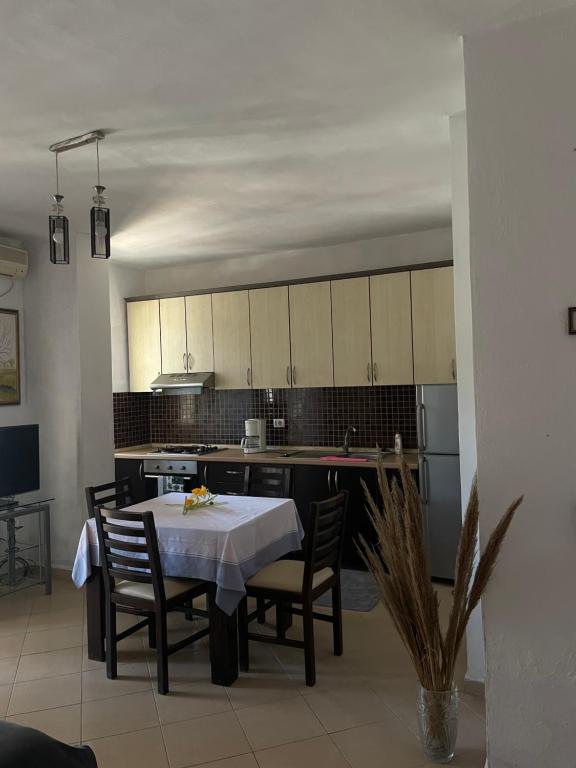a kitchen with a table and chairs and a kitchen with white cabinets at Sior in Golem