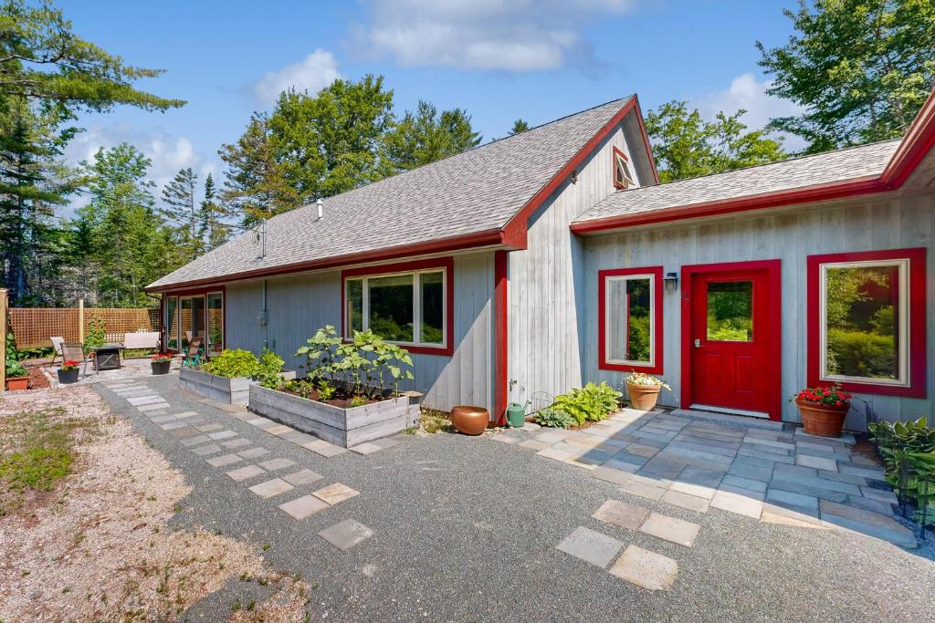 a house with a red door in a yard at Secluded 2 BR Cottage w/ Private W/D, WiFi & Patio in Franklin Road