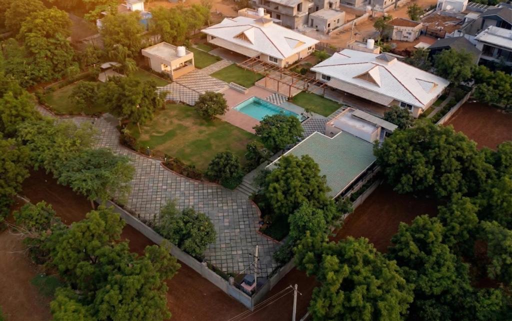 an aerial view of a house with a swimming pool at Dharti in Moinabad