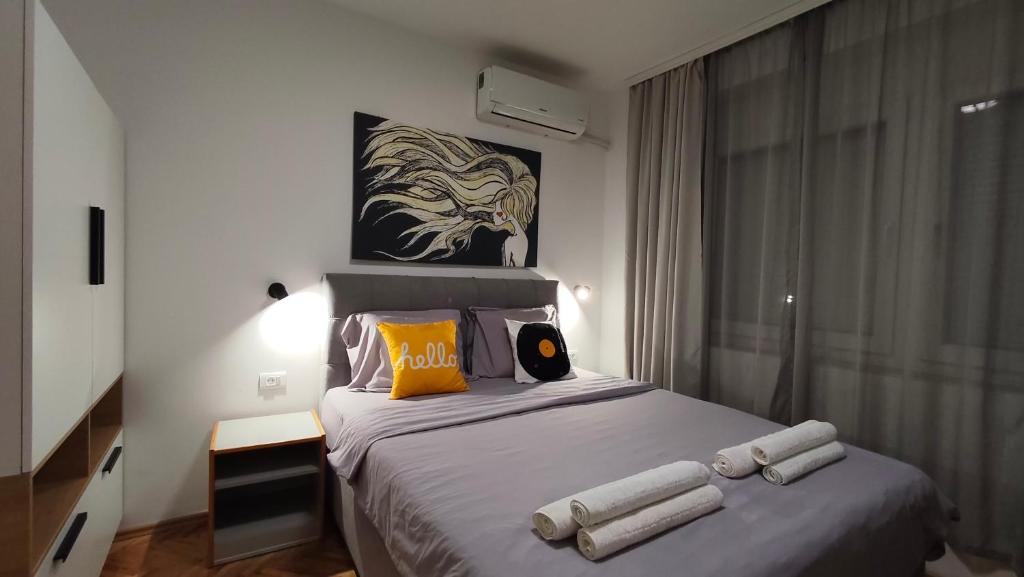 a bedroom with a bed with towels on it at The House Apartments & Guest Rooms in Ohrid