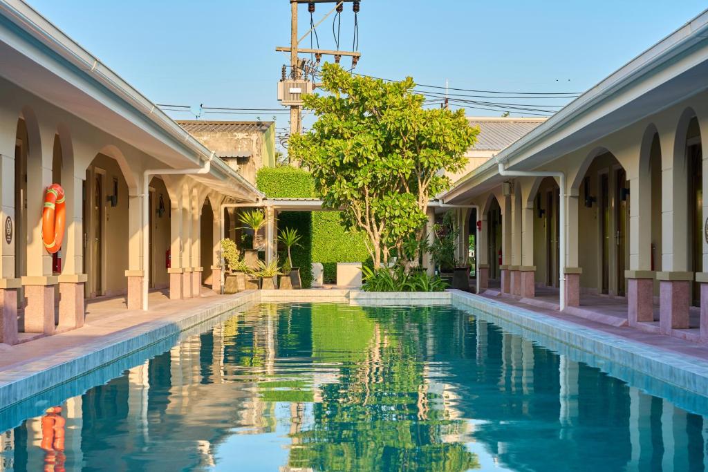 a swimming pool in a courtyard of a building at BARA BARA' Budget SATUN 'SHA Plus' in Satun