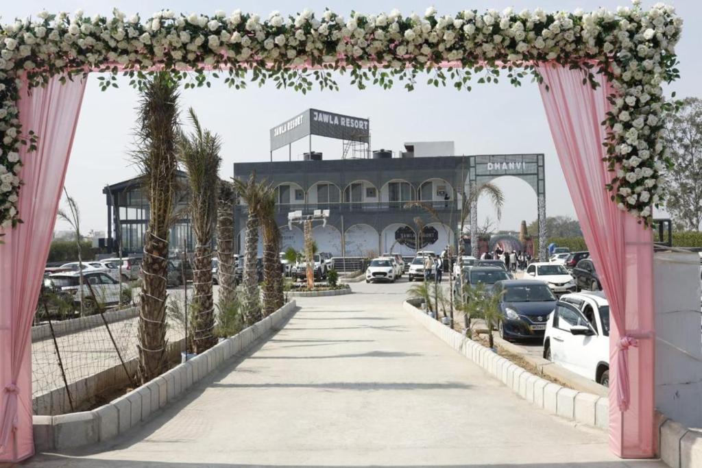 an archway with cars parked in a parking lot at Jawla Resort in Palwal