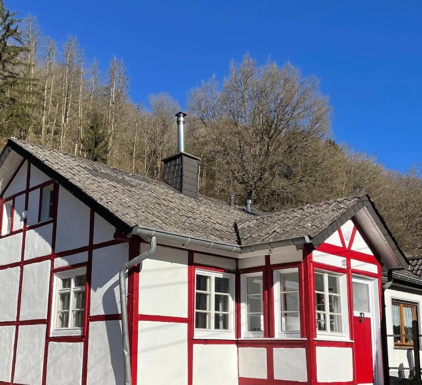 a red and white house with a gray roof at Hilla's Traumhaus in der Eifel in Schleiden