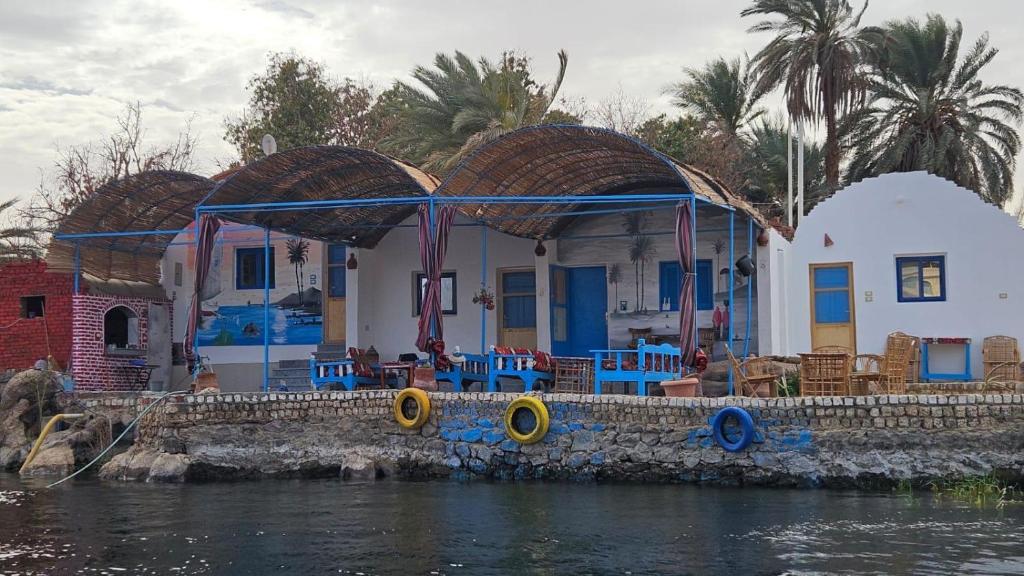 a house on the water next to a body of water at Hannag Island Guest house in Aswan