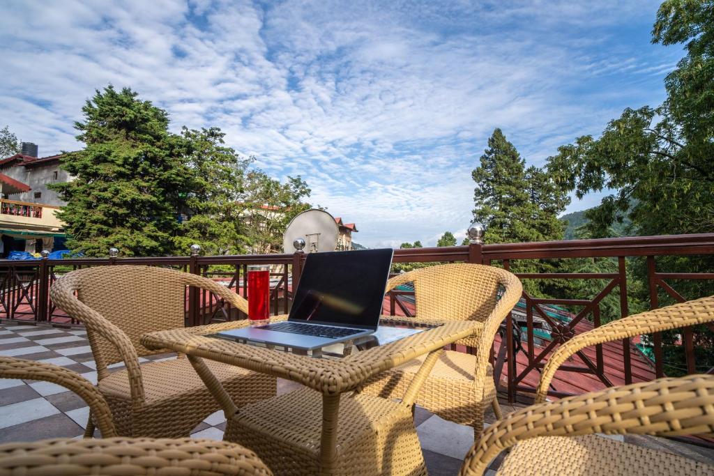 a laptop computer sitting on a table on a patio at New Armadale Nainital in Nainital